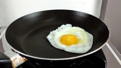 Cooking fried eggs directly in the frying pan Stock Footage 301151423