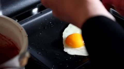 Cooking fried eggs Stock Footage 139867591