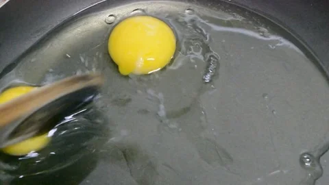 Cooking fried eggs on a frying pan Stock Footage 75166344