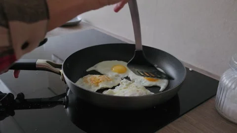 Cooking Fried Eggs in Frying Pan for Breakfast Stock Footage 345834740