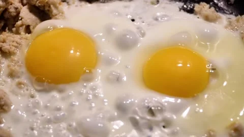 Cooking fried eggs with minced meat for breakfast. Stock Footage 318459277