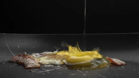 Cooking fried eggs or scrambled eggs with bacon on hot skillet for Breakfast Stock Footage 123576731