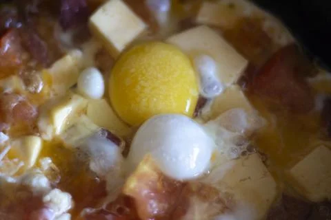 Cooking fried eggs in a pan Stock Photos