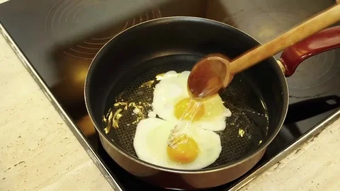 Cooking fried eggs stop motion Stock Footage 83387675