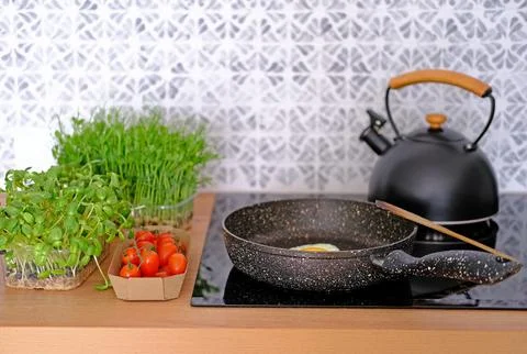 Cooking fried eggs with vegetables for breakfast or snack Stock Photos