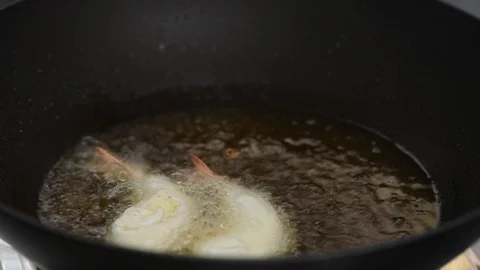 Cooking fried prawn balls in a hot pan Stock Footage 97063702