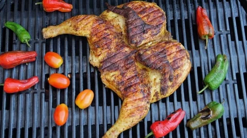Cooking fried roast Chicken Tabaka on grill with vegetables.Tobacco chicken Stock Footage 246770416
