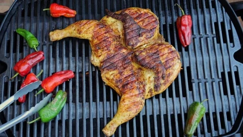 Cooking fried roast Chicken Tabaka on grill with vegetables.Tobacco chicken Stock Footage 246770417