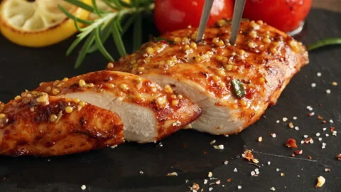 Cooking fried roasted chicken breasts cut knife. lemon tomato mustard  honey Stock Footage 89453523