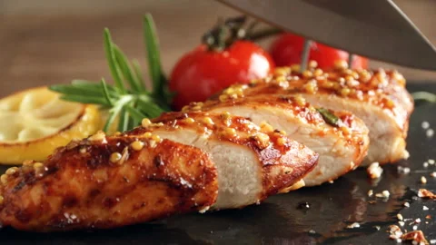 Cooking fried roasted chicken breasts cut knife. lemon tomato  mustard honey Stock Footage 89453549
