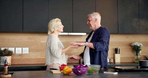 Cooking, fun or old couple in kitchen with dancing, playful moment or bonding in Stock Footage 336854398