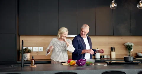 Cooking, fun or old couple in home with dance, happy moment or bonding in meal Stock Footage 336856752
