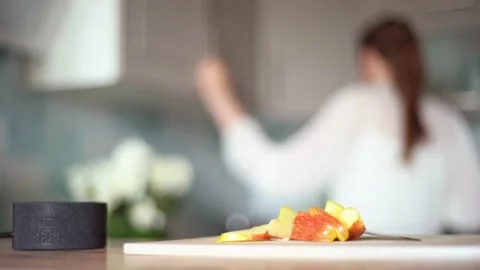 Cooking with the functions of a smart home. A young woman uses a voice assistant Video stock 130849873