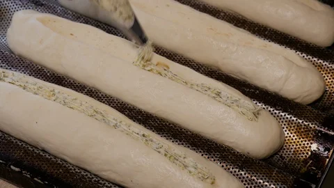 Cooking garlic bread in bakery Stock Footage 108098299