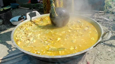 Cooking goat meat curry in an extra large pan Stock Footage 243090891