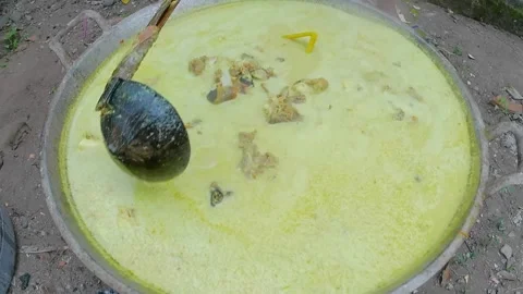Cooking goat meat curry in an extra large pan Stock Footage 243091905