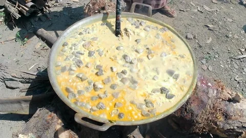 Cooking goat meat curry in an extra large pan Stock Footage 243093075