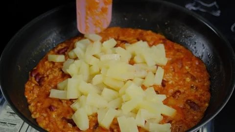 Cooking Grains and Beans in a Black Frying Pan with Spatula Stock Footage 341436965