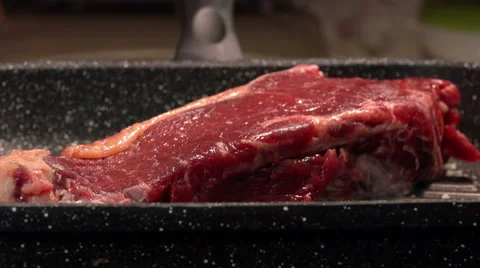 Cooking on the grill a piece of red beef: cook a steak on the grill Stock Footage 61355412
