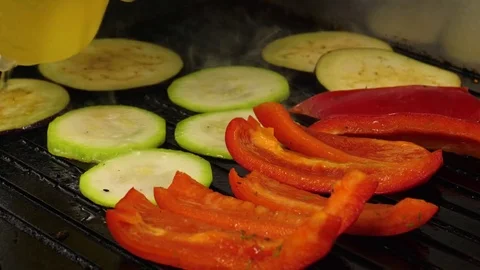 Cooking grilled vegetables, Chef adds oil on the frying surface, 4K 60 FPS Stock Footage 76952317