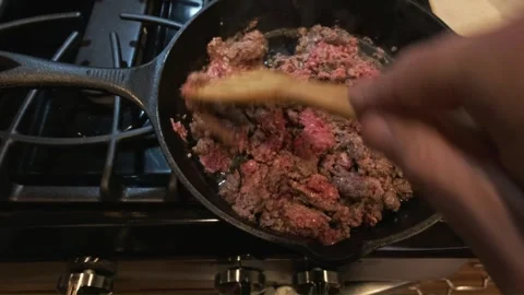 Cooking ground beef in a black iron skillet Stock Footage 329400775