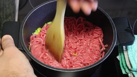 Cooking ground meat in a pot with fresh vegetables for flavorful dishes Stock Footage 294630533