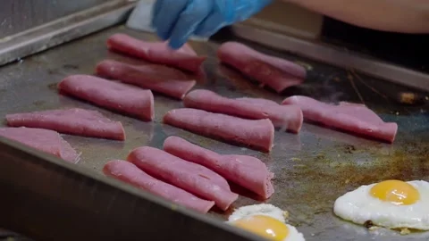 Cooking ham slices on a grill at a kitchen Stock Footage 339755532