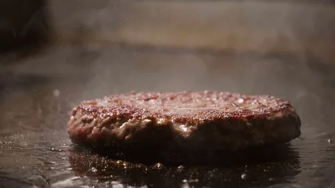 Cooking hamburger. Beef or pork cutlet frying on grill. Slow motion. HD Stock-Footage 85049287