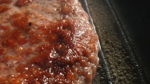 Cooking hamburger. Beef or pork cutlet grilling on grid. Slow motion. HD Stock-Footage 115773740