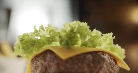 Cooking hamburger. Close-up of chef with his hands covering juicy burger with Stock Footage 116178367