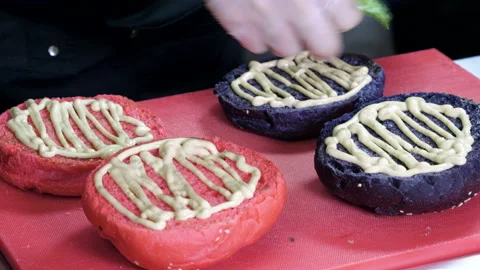 Cooking hamburger. Cook preparing burger with cutlet, smoked bacon, shrimps. 4K Stock Footage 98110163
