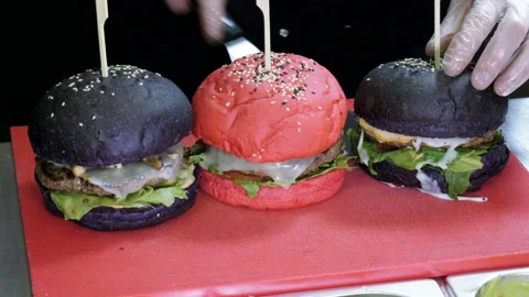 Cooking hamburger. Cook preparing burger with cutlet, smoked bacon, shrimps. 4K Video stock 98111096