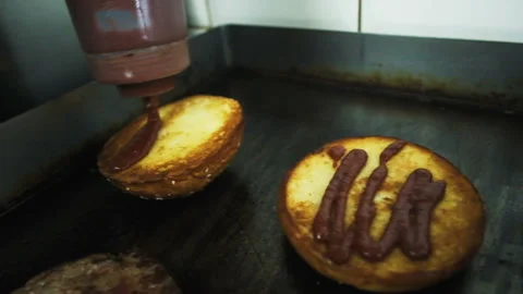 Cooking a hamburger. Grilled beef or pork cutlets. Slow motion. HD Stock Footage 123755932