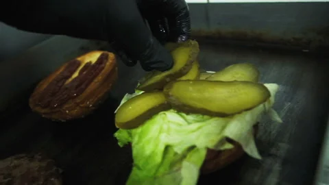 Cooking a hamburger. Grilled beef or pork cutlets. Slow motion. HD Stock Footage 123755964