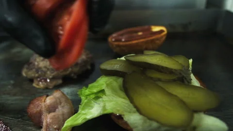 Cooking a hamburger. Grilled beef or pork cutlets. Slow motion. HD Stock Footage 123756002