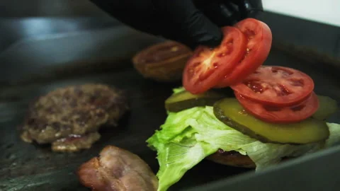 Cooking a hamburger. Grilled beef or pork cutlets. Slow motion. HD Stock Footage 123756028
