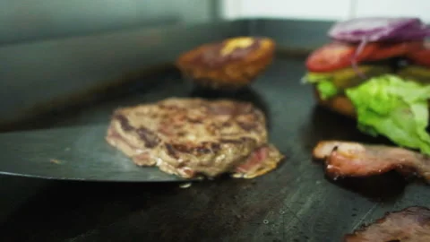 Cooking a hamburger. Grilled beef or pork cutlets. Slow motion. HD Stock Footage 123756080