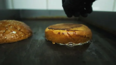 Cooking a hamburger. Grilled beef or pork cutlets. Slow motion. HD Stock Footage 123756232