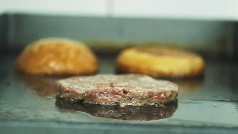 Cooking a hamburger. Grilled beef or pork cutlets. Slow motion. HD Stock Footage 123756285