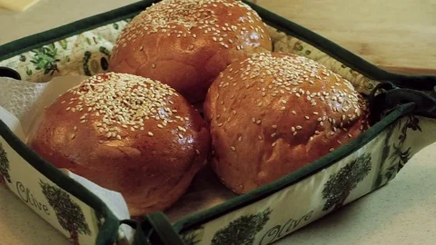 Cooking hamburger. Three bread rolls with sesame seeds prepared for burgers. HD 動画素材 70660853