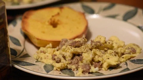 Cooking handheld adding cheese to sausage scrambled eggs Stock Footage 93969852
