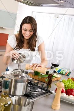 Cooking - happy woman cook in modern kitchen Stock Photos