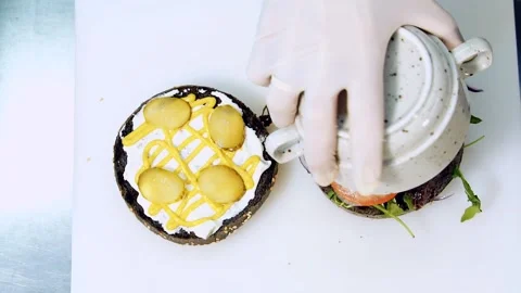 Cooking healthy snack. Chef making vegan hamburger putting fresh vegetable Stock Footage 318310325