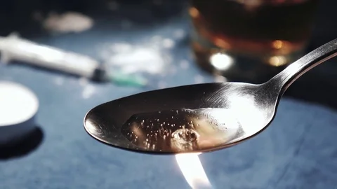 Cooking Heroin on a spoon Stock-Footage 82284045
