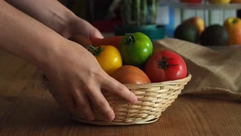 Cooking at home, woman picking up colorful tomatoes on a kitchen table Stock Footage 197427001