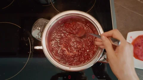 Cooking homemade raspberry jam in the kitchen from fresh ingredients Stock Footage 320952711