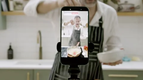 Cooking Influencer Filming Cooking Tutorial on Smartphone in Modern Kitchen 스톡 동영상 328761267