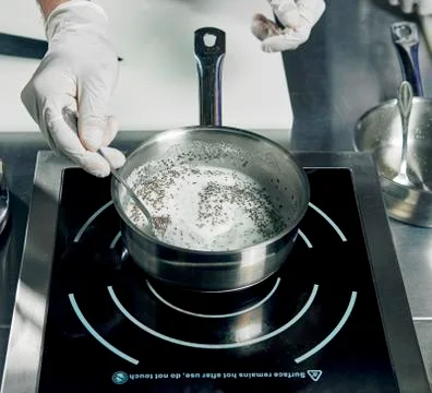 Cooking ingredients in pan in the kitchen Stock Photos
