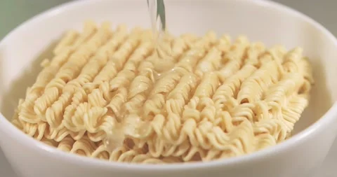 Cooking instant noodles. Pour boiling water over the noodles. Super slow moti Stock Footage 148773371