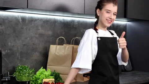 Cooking with joy in a modern kitchen filled with fresh ingredients 스톡 동영상 296318554